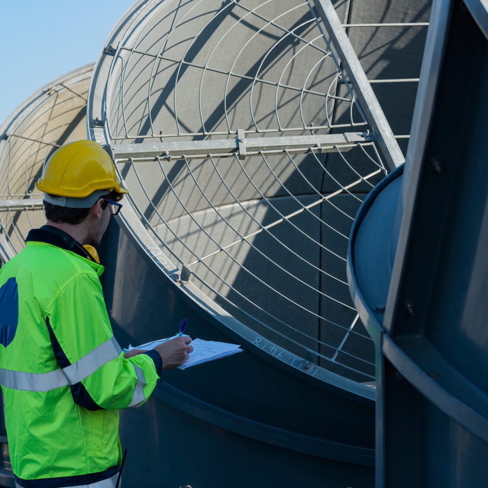 Worker,Checklist,Of,Cooling,Tower,On,Blue,Sky,Background.,Worker